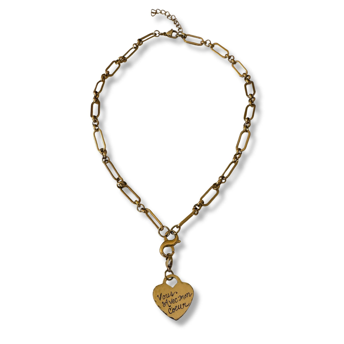 Gold chain necklace with a heart-shaped pendant on a white background